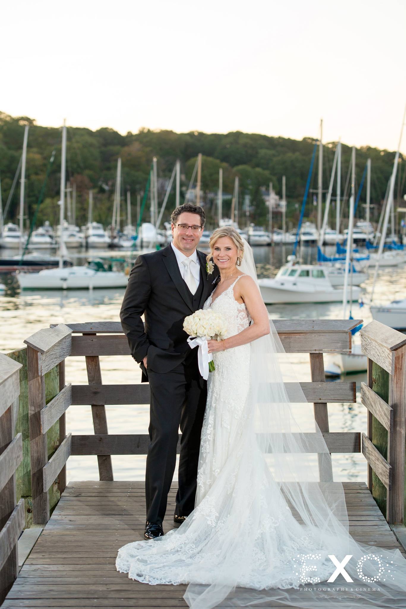 bride and groom on dock at harbor club at prime