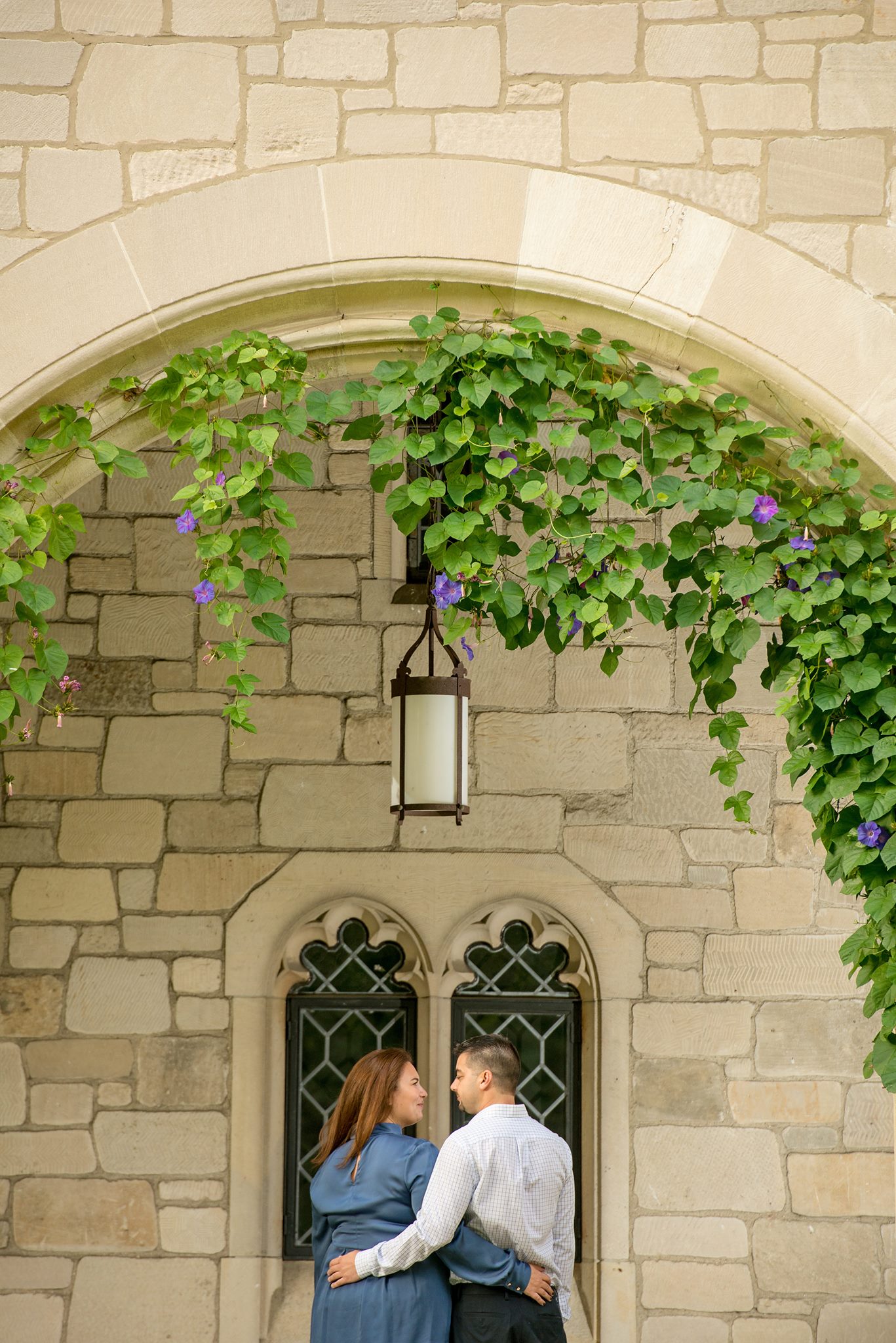 couple under archway with vines