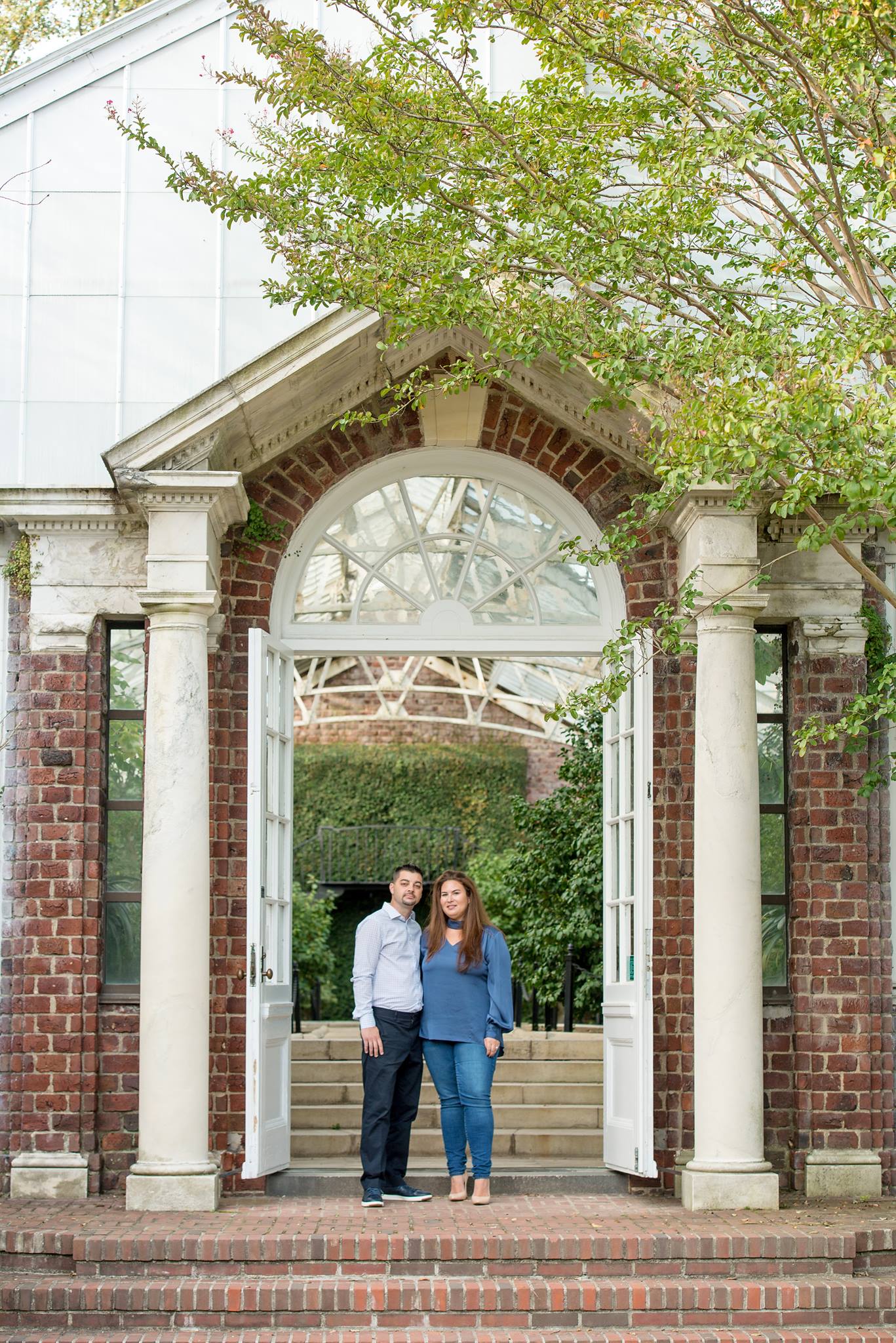 engaged couple near entryway to Planting Fields Arboretum