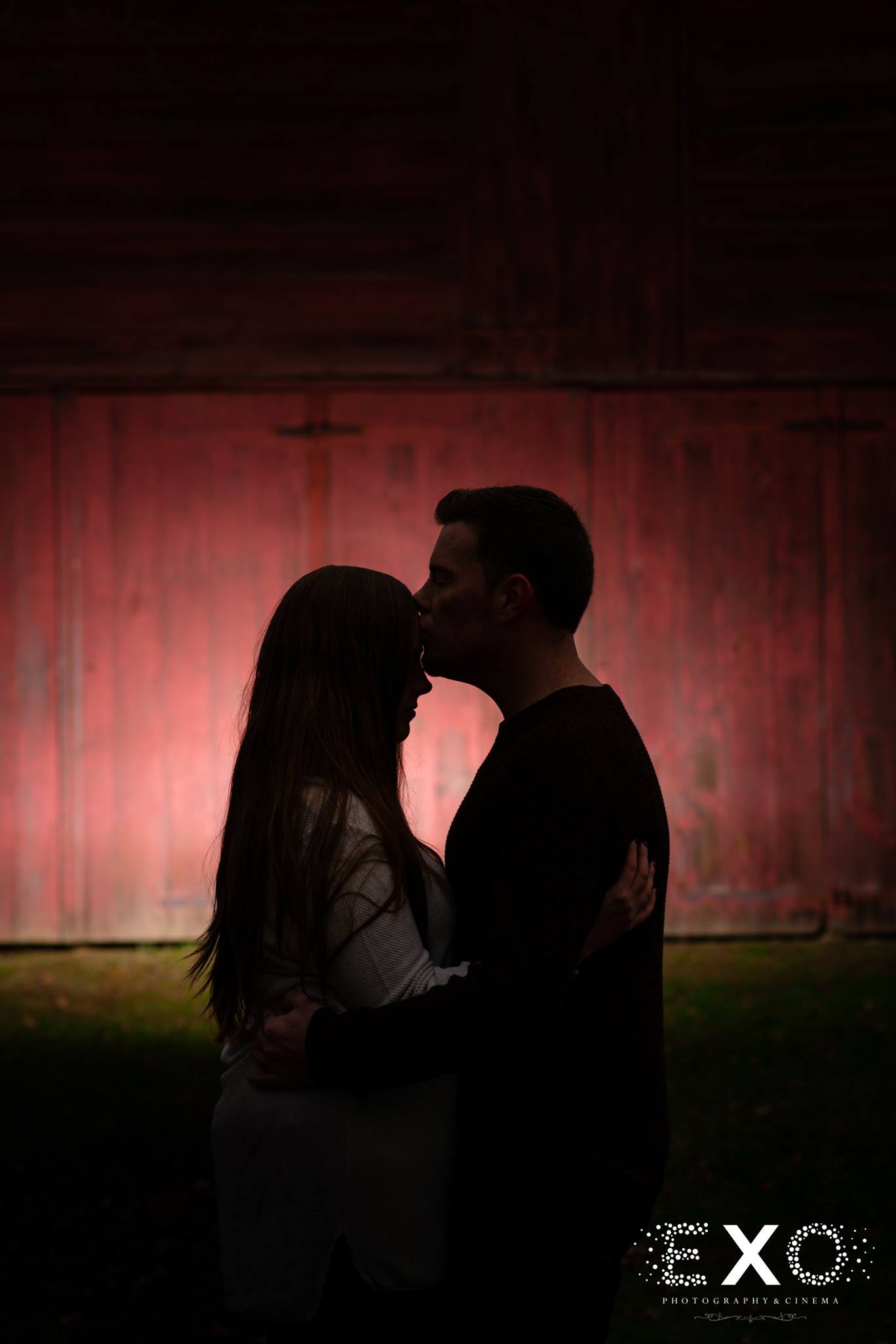 dark silhouette shot of couple kissing