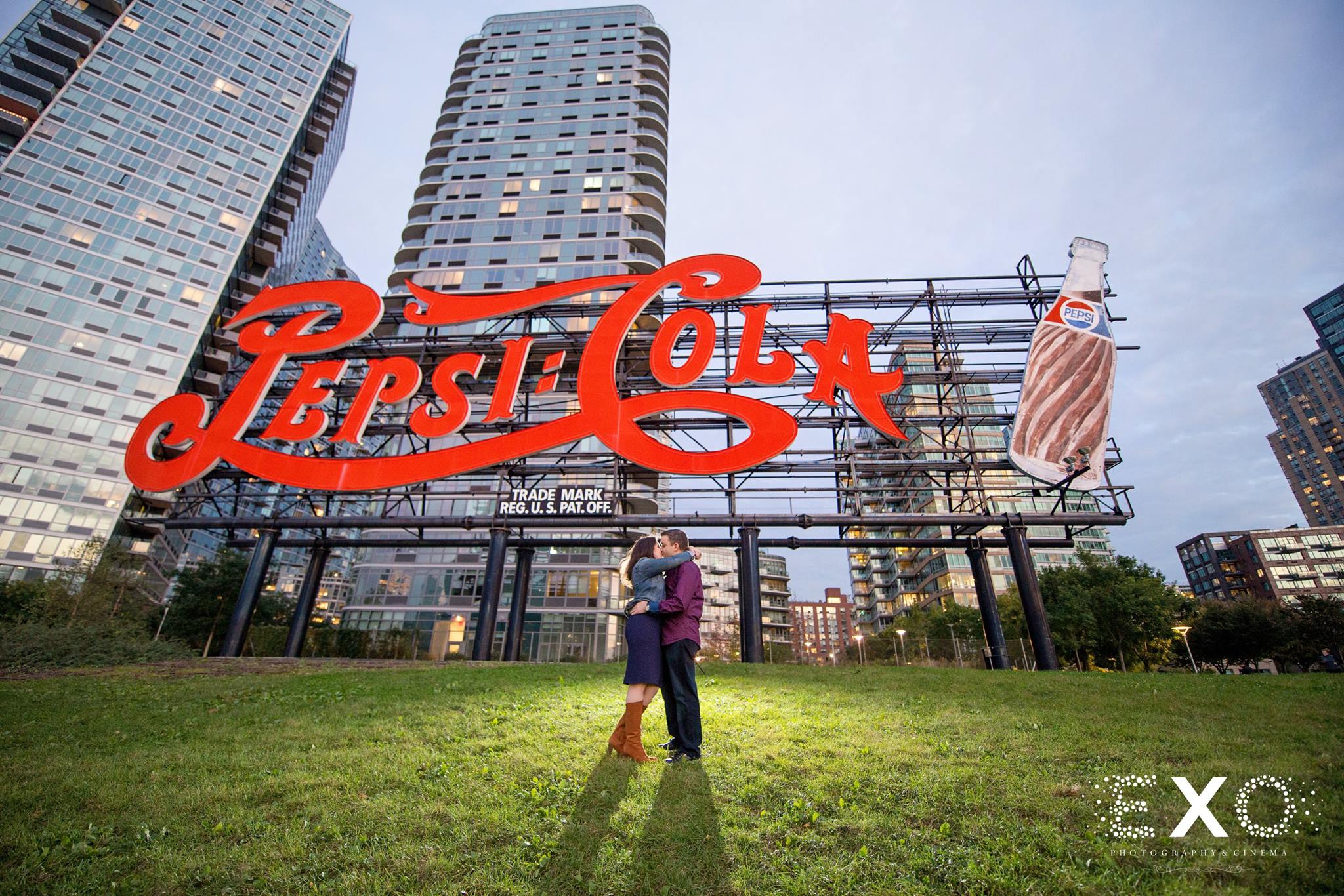 couple kissing in front of pepsi cola sign at Gantry Park