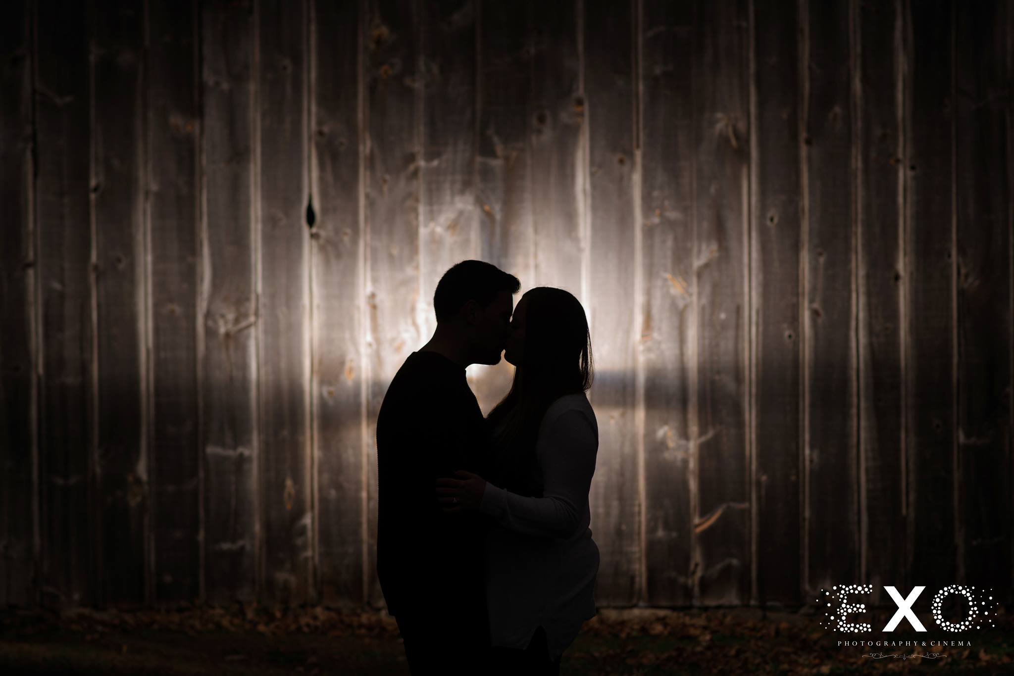 silhouette shot of couple in front of barn at Old Bethpage Village Restoration engagement session