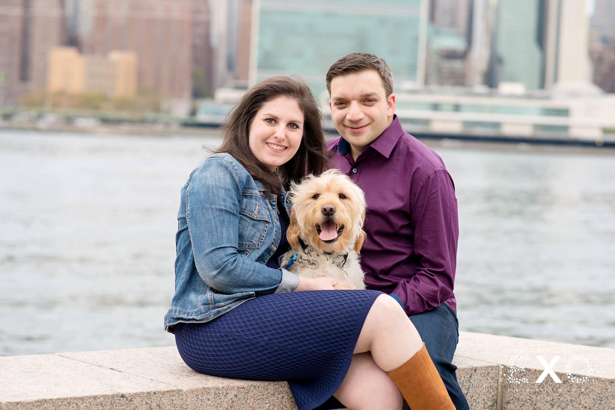 couple near water at Gantry Park with dog during engagement shoot