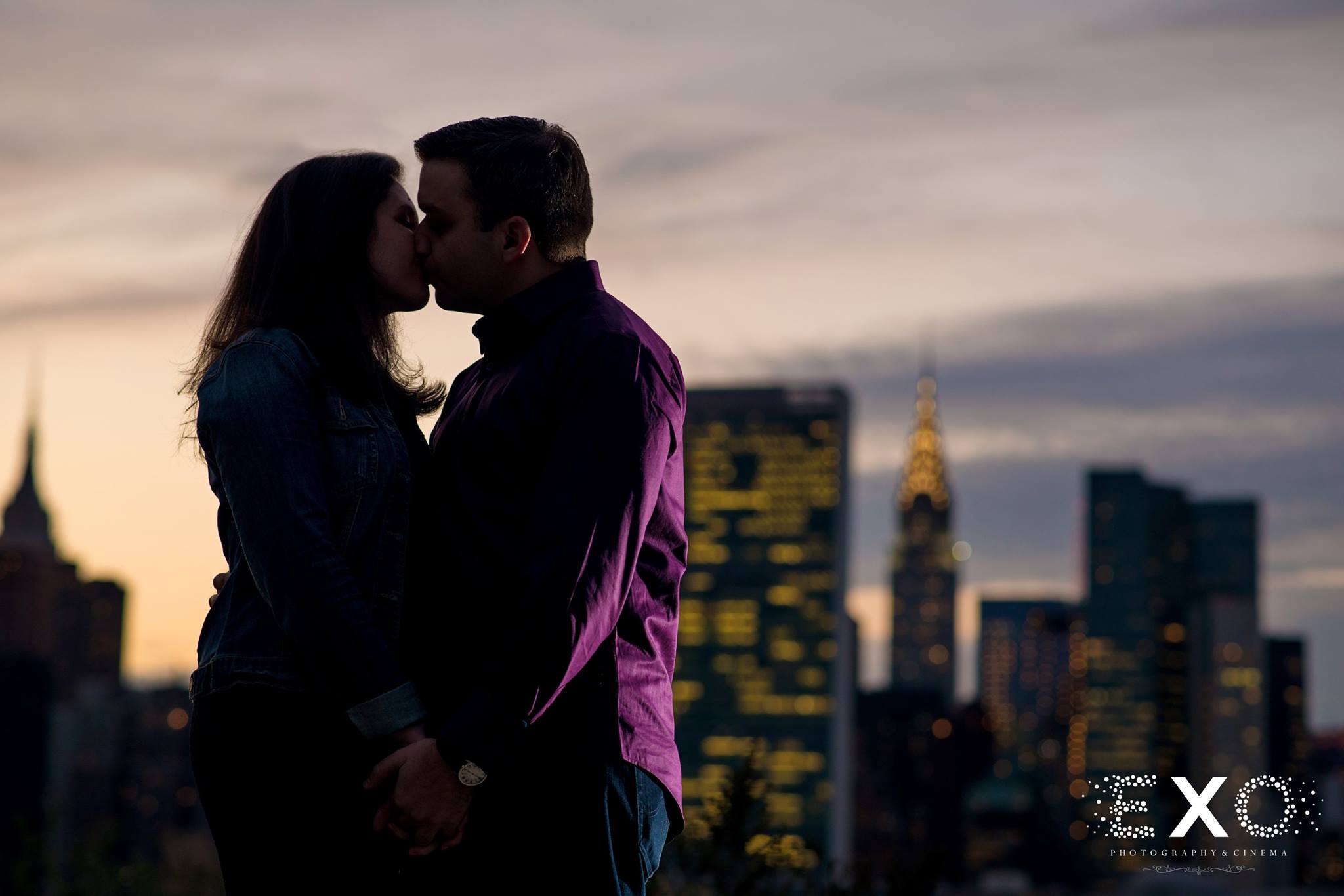 silhouette shot of couple with new york skyline by Gantry Park