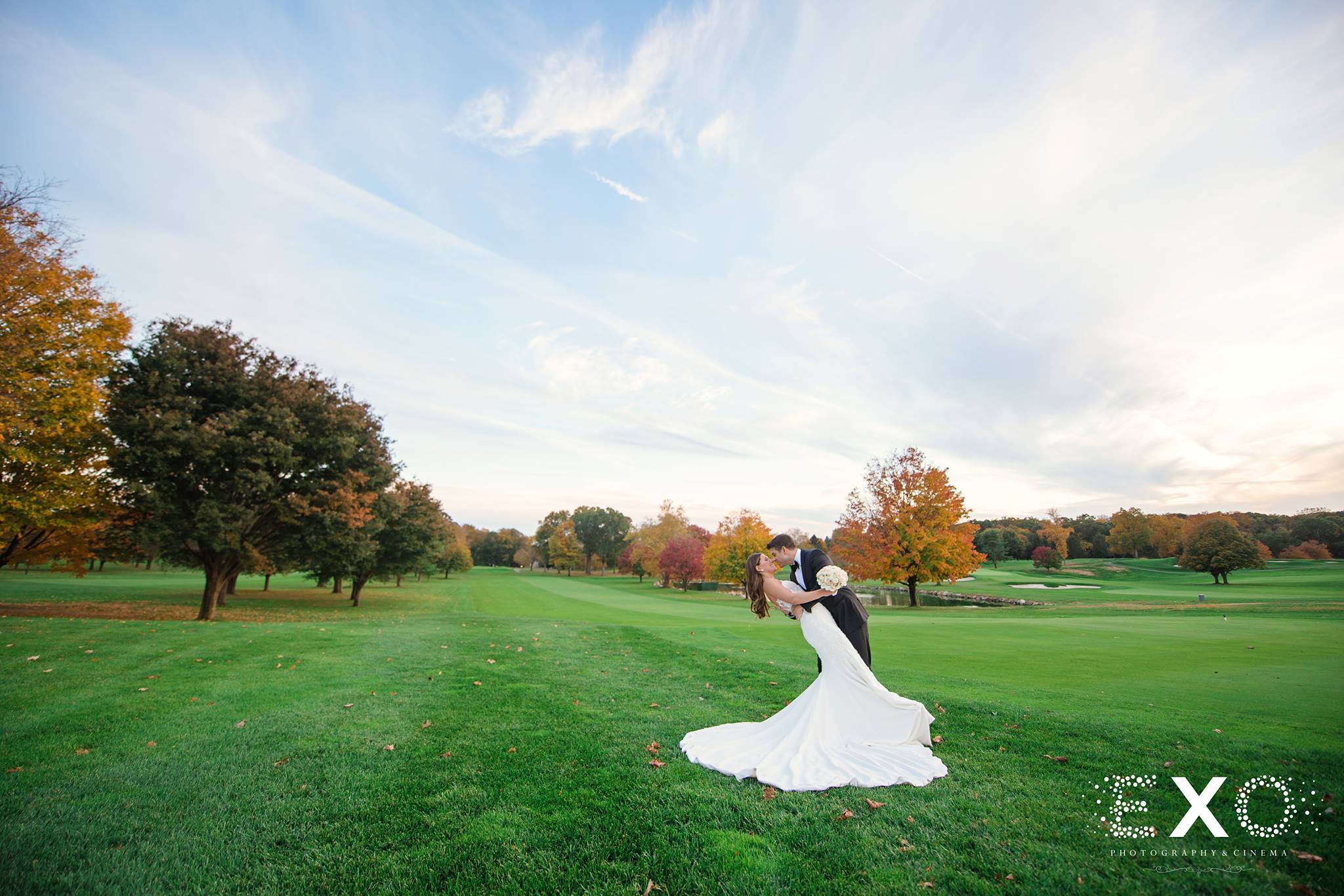 bride and groom kissing on grass at Glen Head Country Club wedding