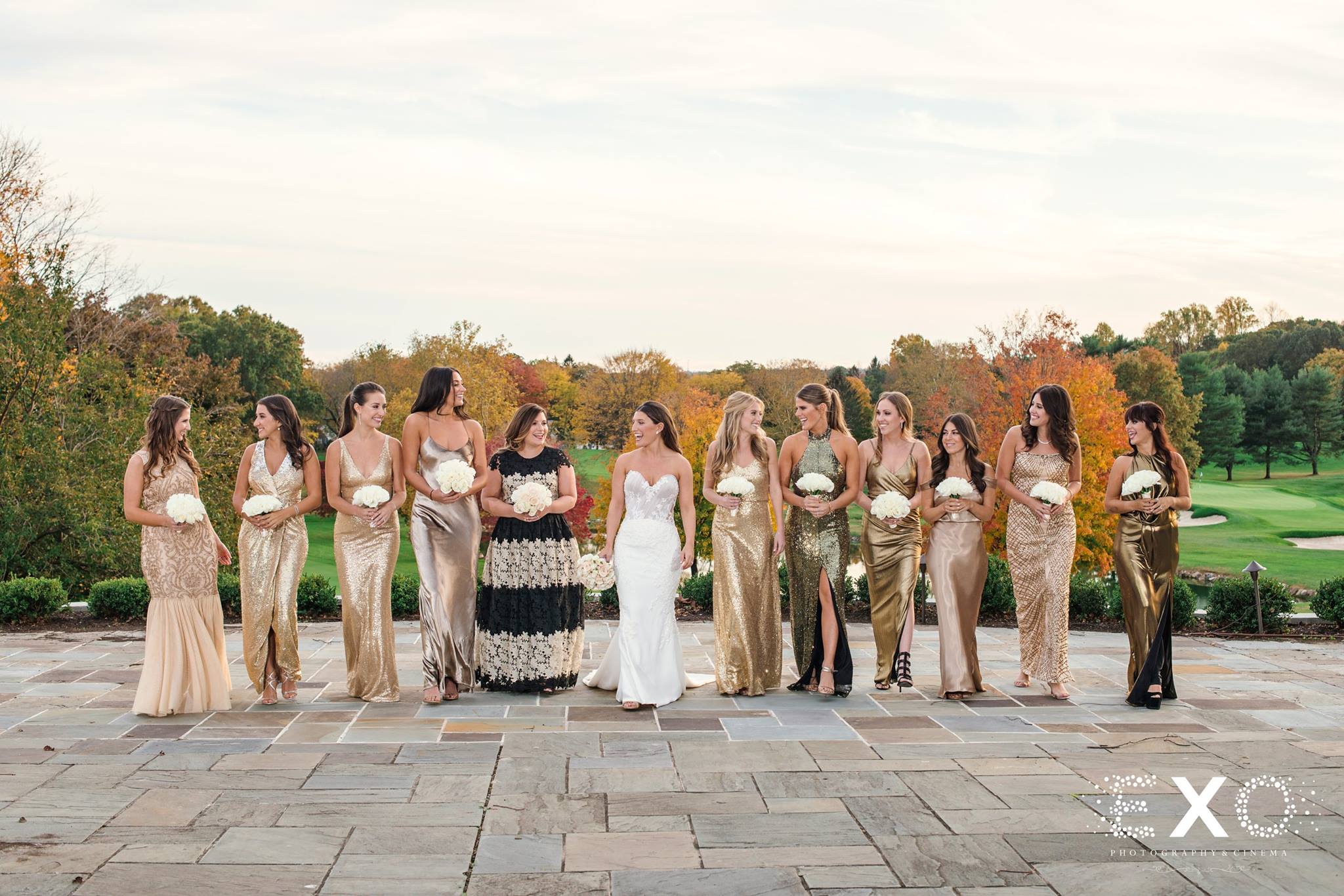 bride and bridesmaids smiling together at Glen Head Country Club fall wedding