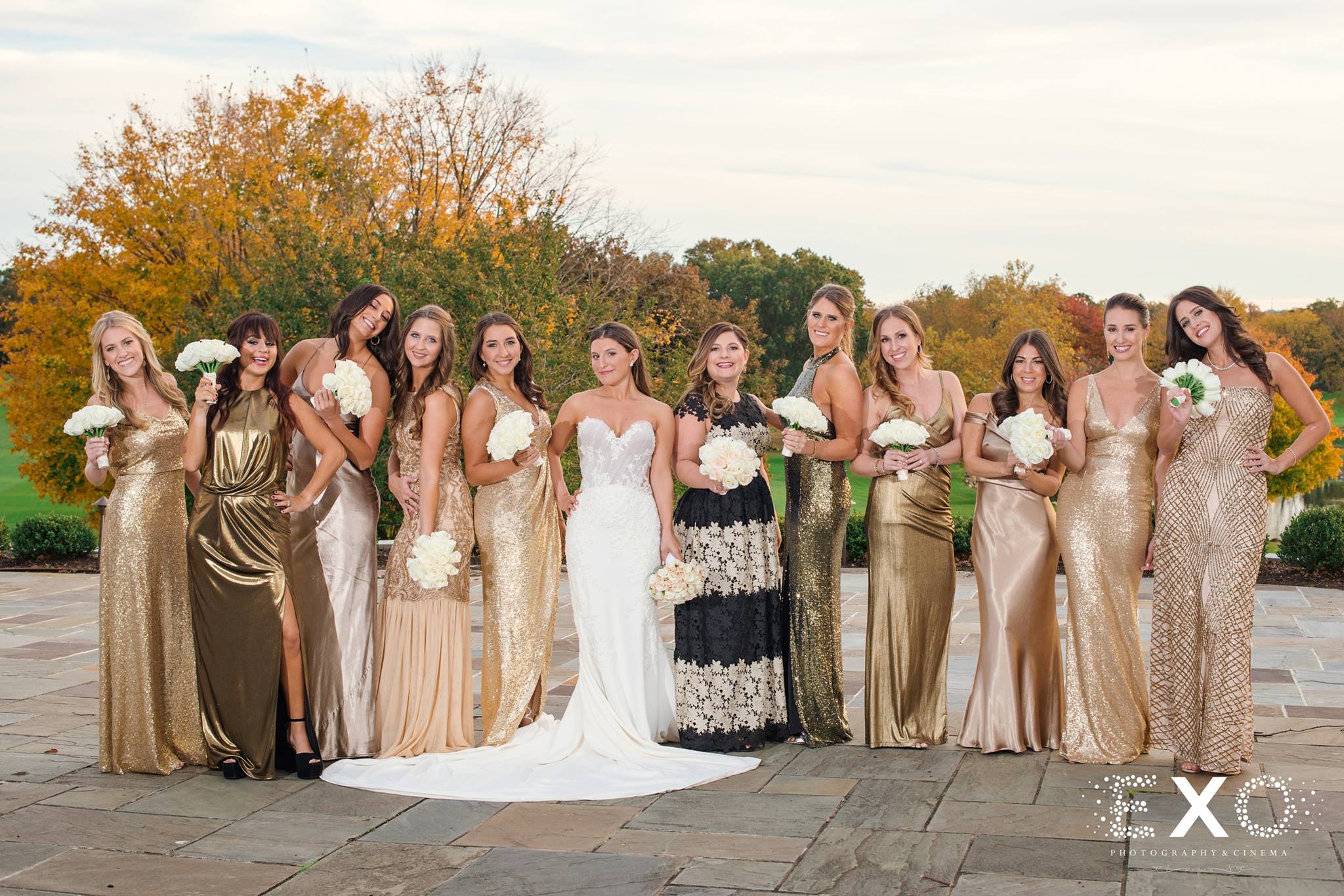bride wearing kleinfeld bridal gown and bridesmaids wearing a variety of dresses