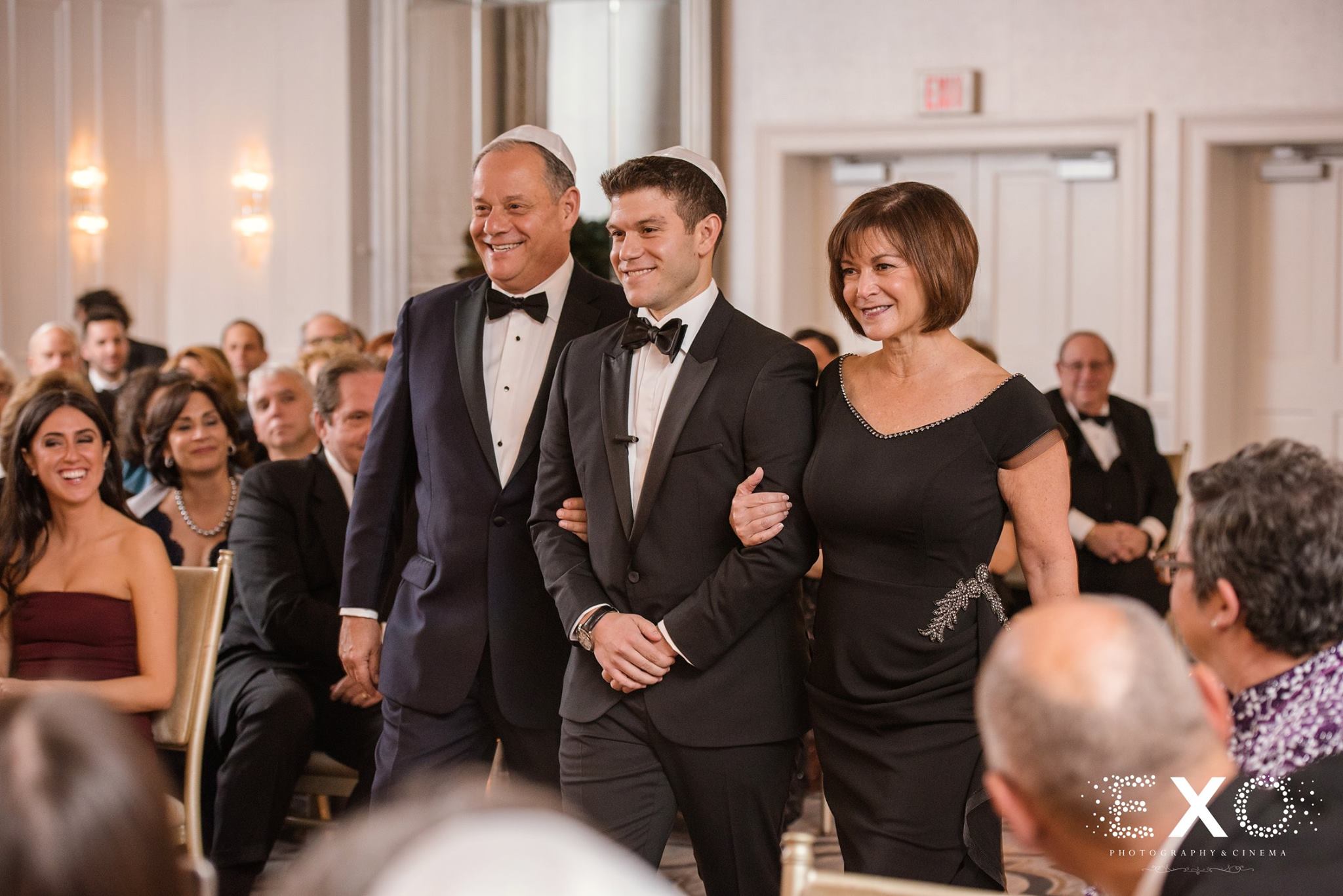groom walking down aisle with parents during Glen Head Country Club wedding