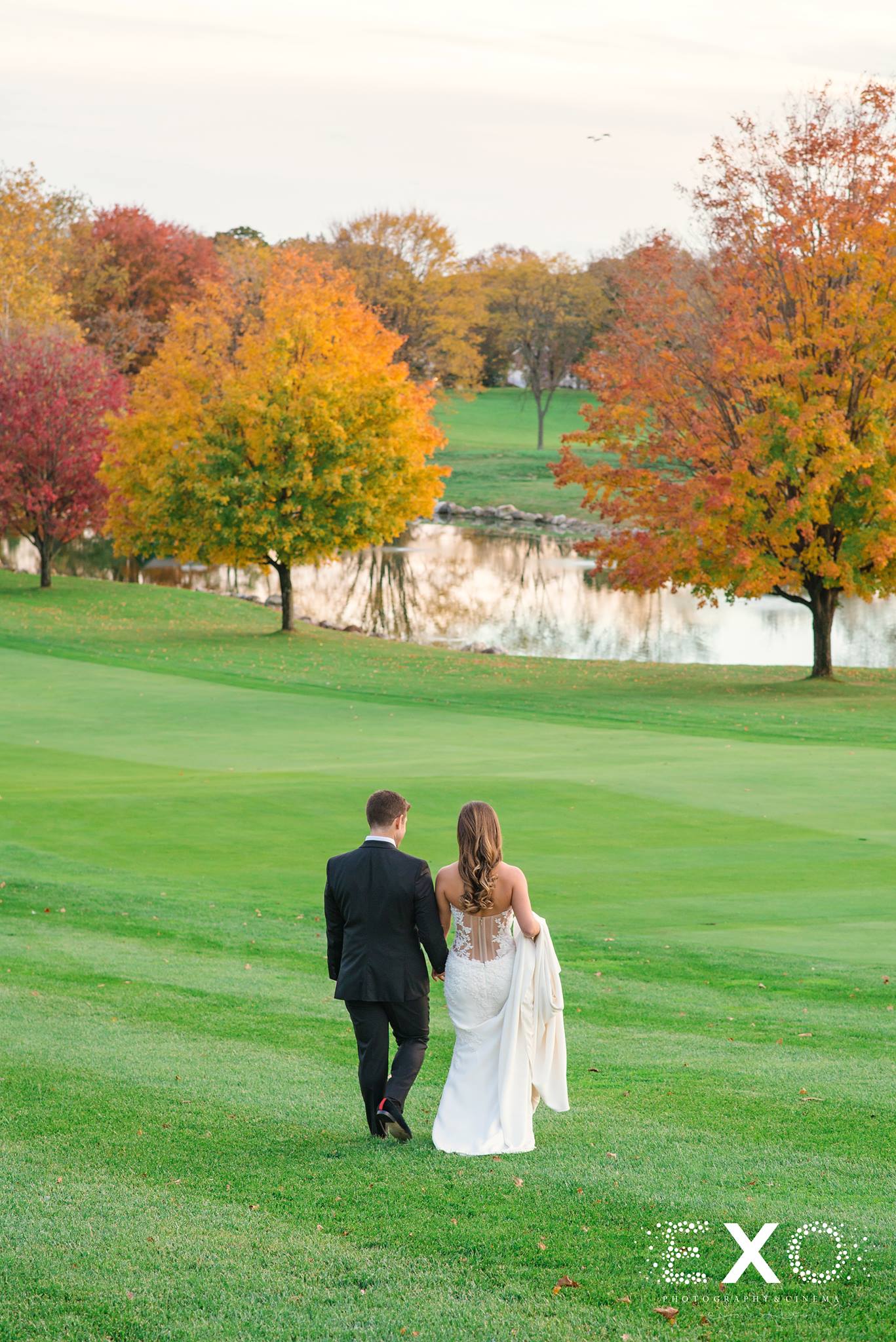 bride and groom walking on greens of Glen Head Country Club