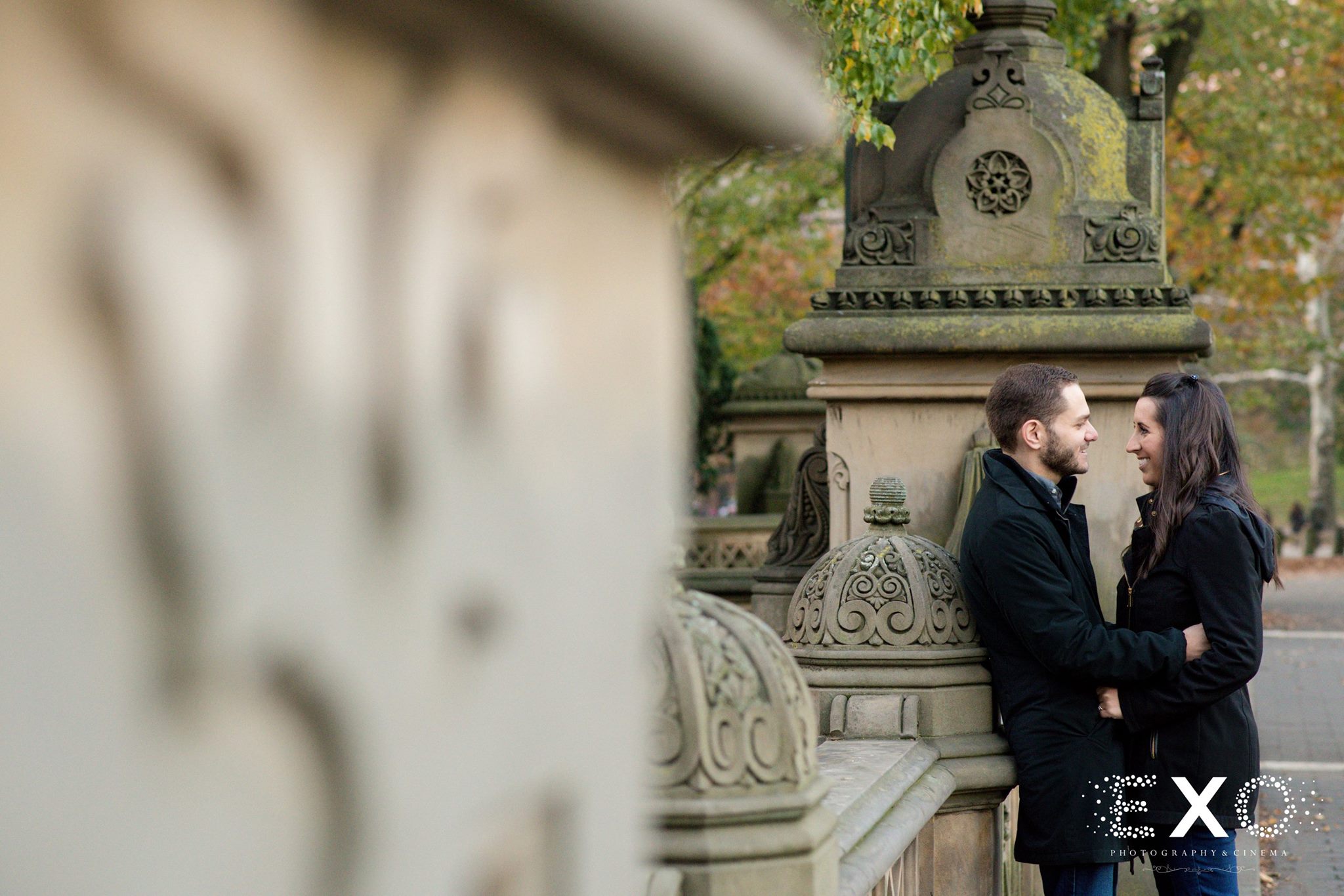 couple standing in central park during fall engagement session
