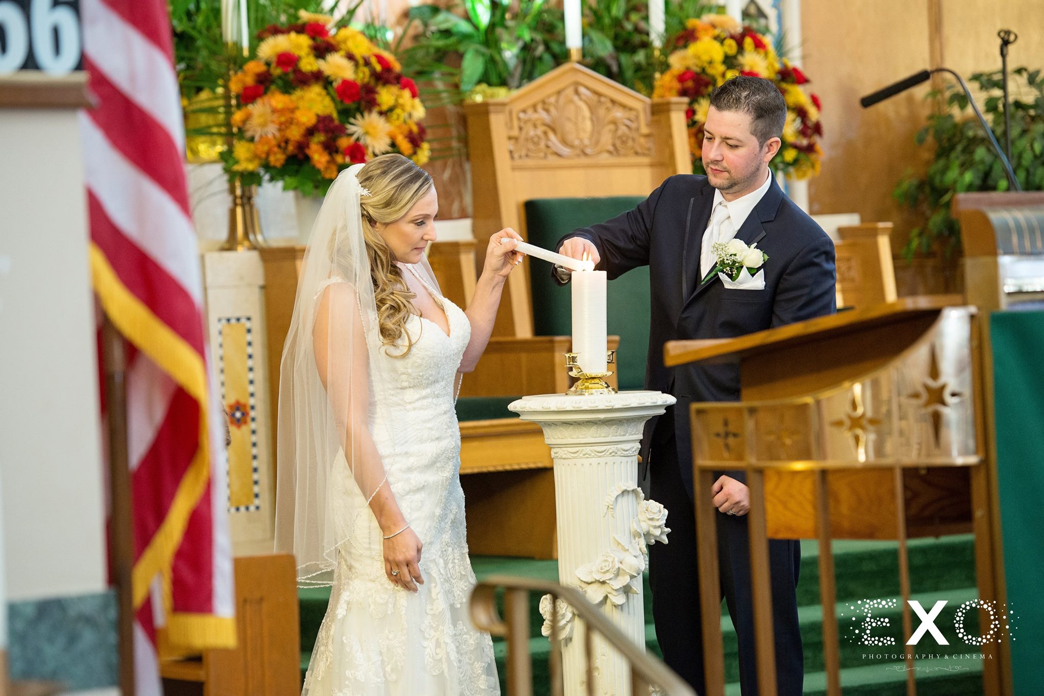 bride and groom lighting candle at long island wedding ceremony