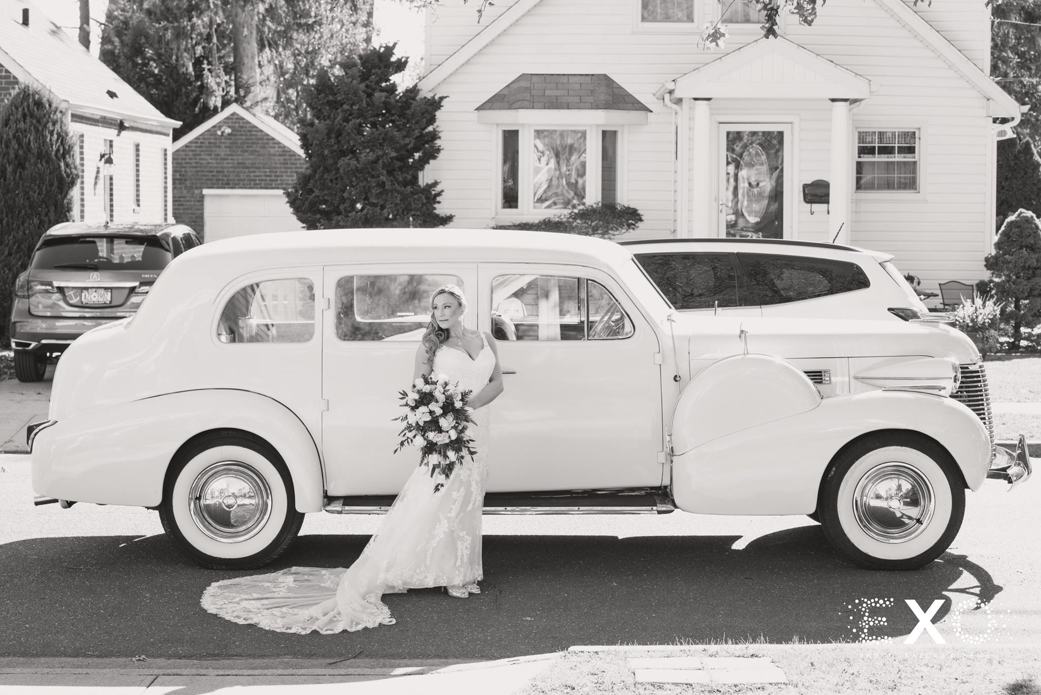 black and white image of bride with car by M&V transportation