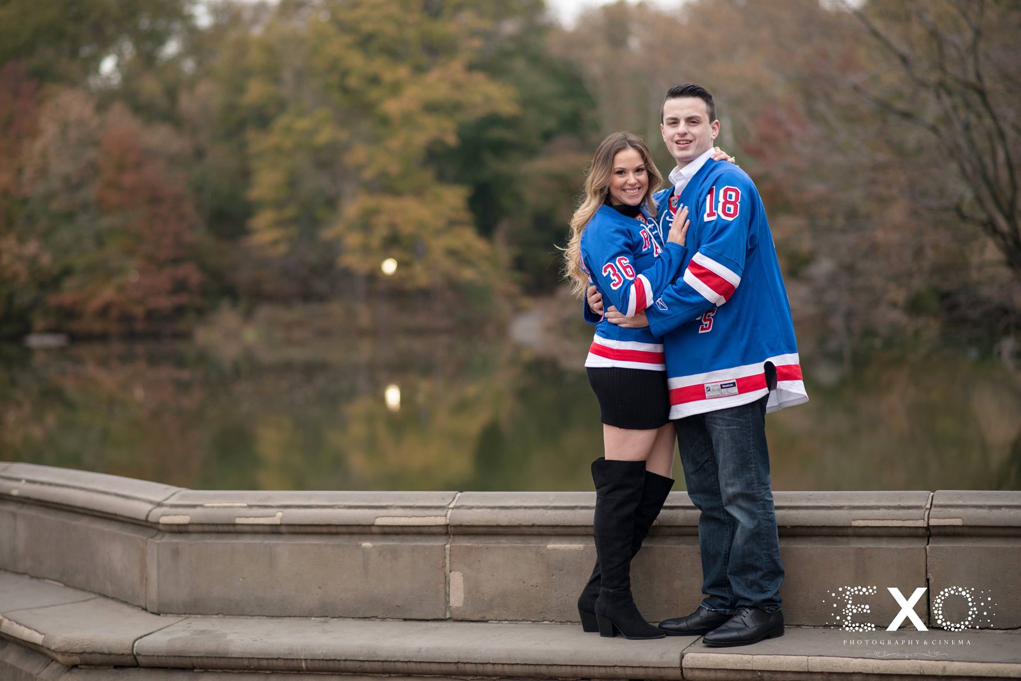 couple at Central Park engagement session wearing team jerseys
