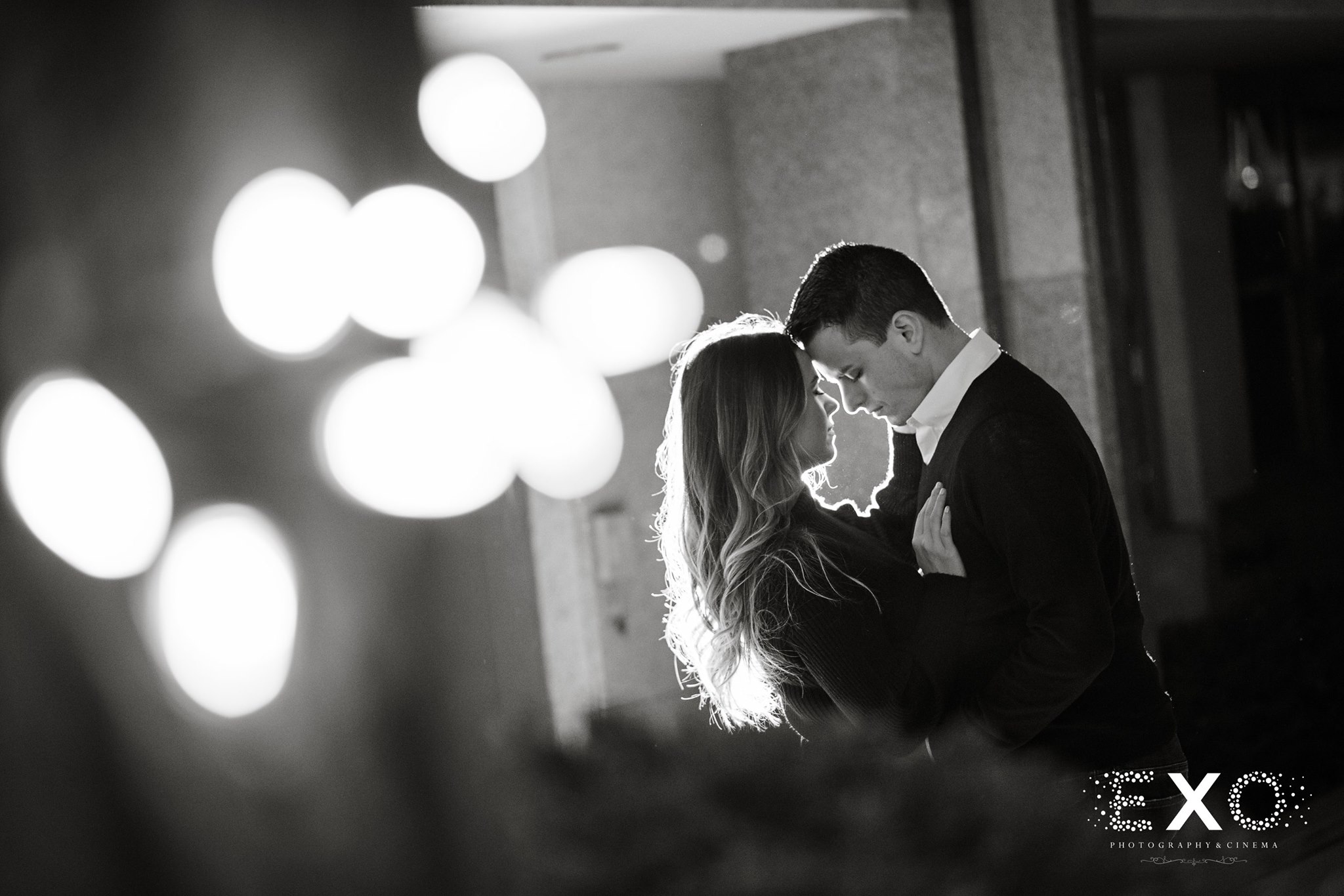 black and white shot of couple with bright lights
