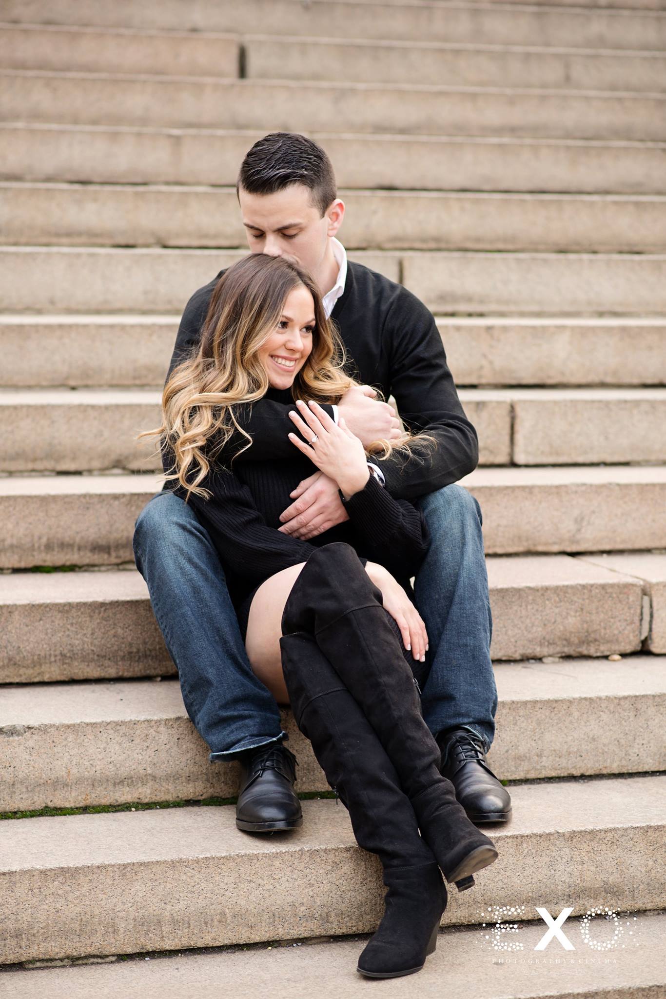 couple holding each other on stairs at Central Park engagement session