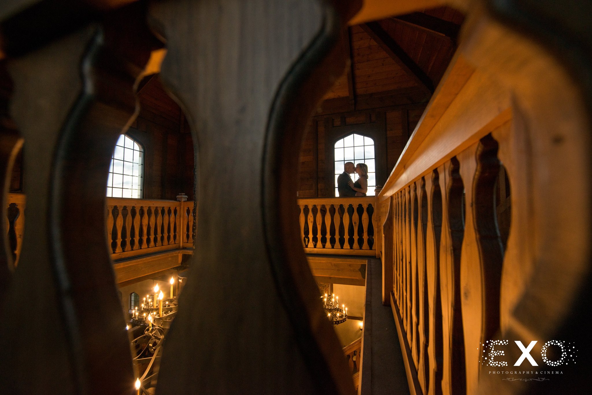 perspective shot of couple kissing near window at Raphael Vineyard engagement session
