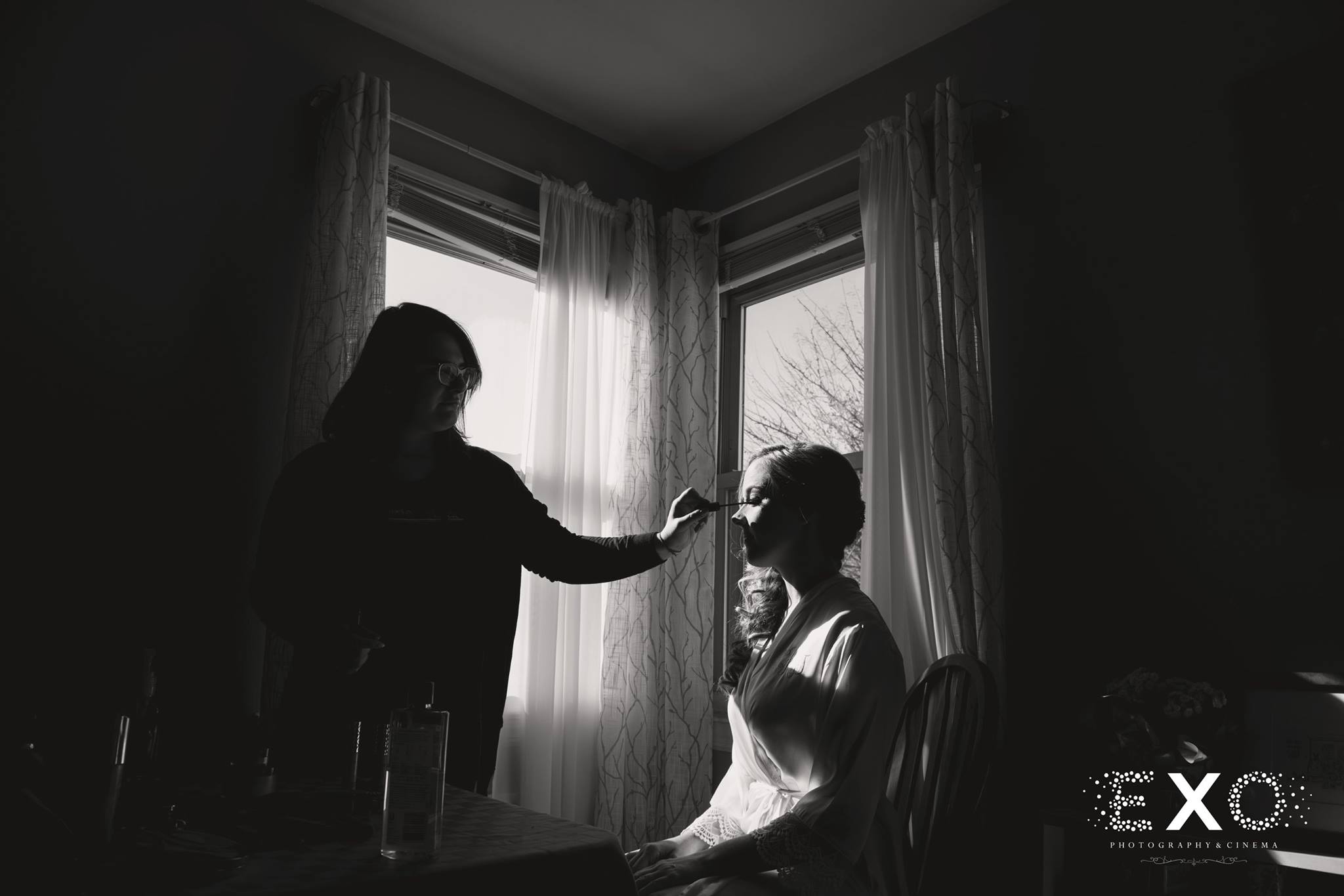 black and white image of bride getting hair and makeup done by Metamorphosis NY