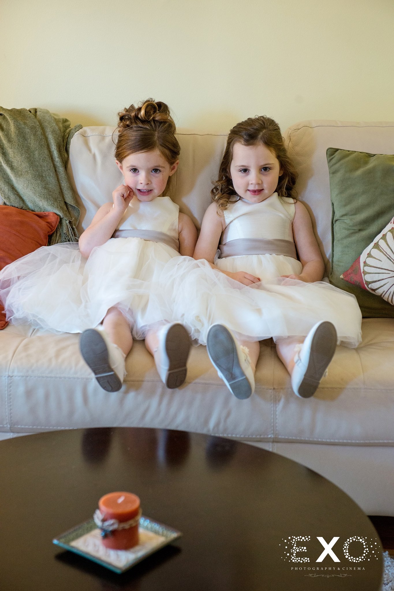flower girls waiting on couch before Heritage Club at Bethpage wedding ceremony