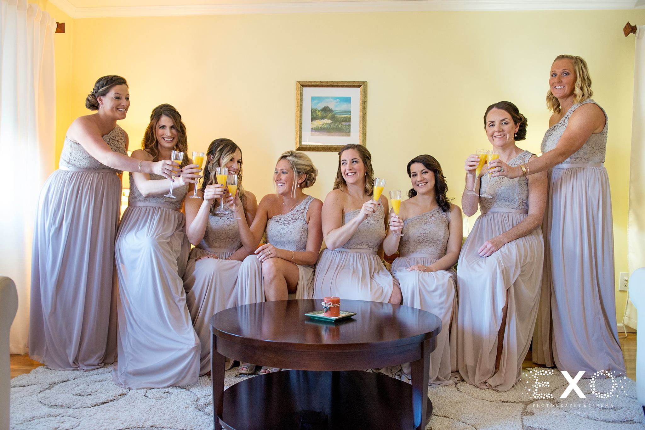 bridesmaids wearing davids bridal gowns sipping champagne