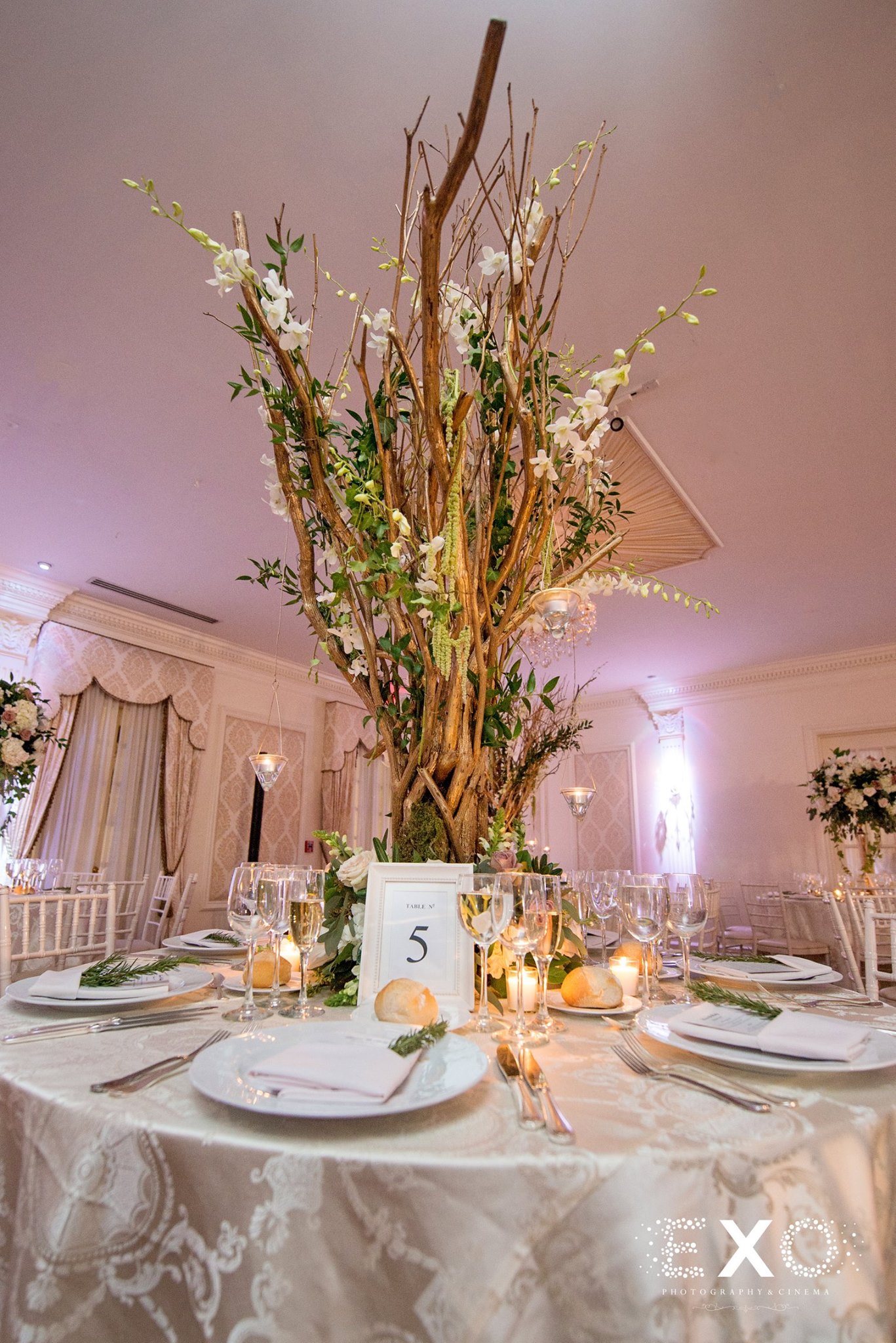 table setting with floral arrangements by pedestals