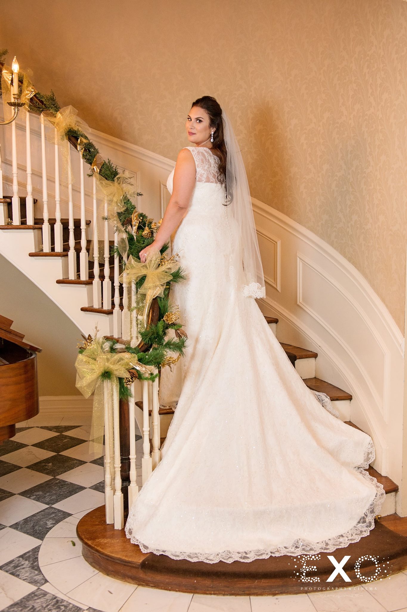 bride on stairs wearing Kleinfeld bridal designed by Augusta Jones