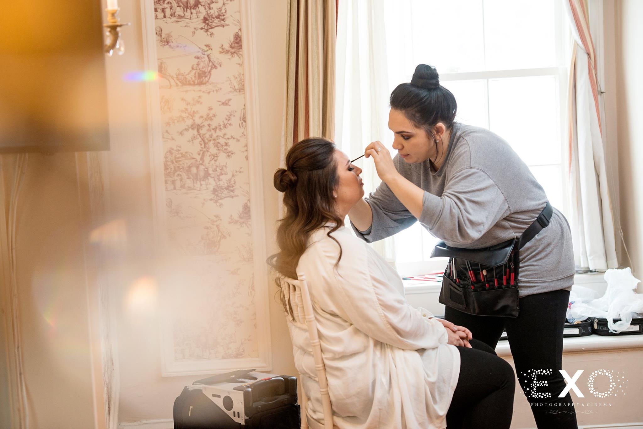 bride getting hair and makeup done before Royalton at Roslyn mansion winter wedding ceremony