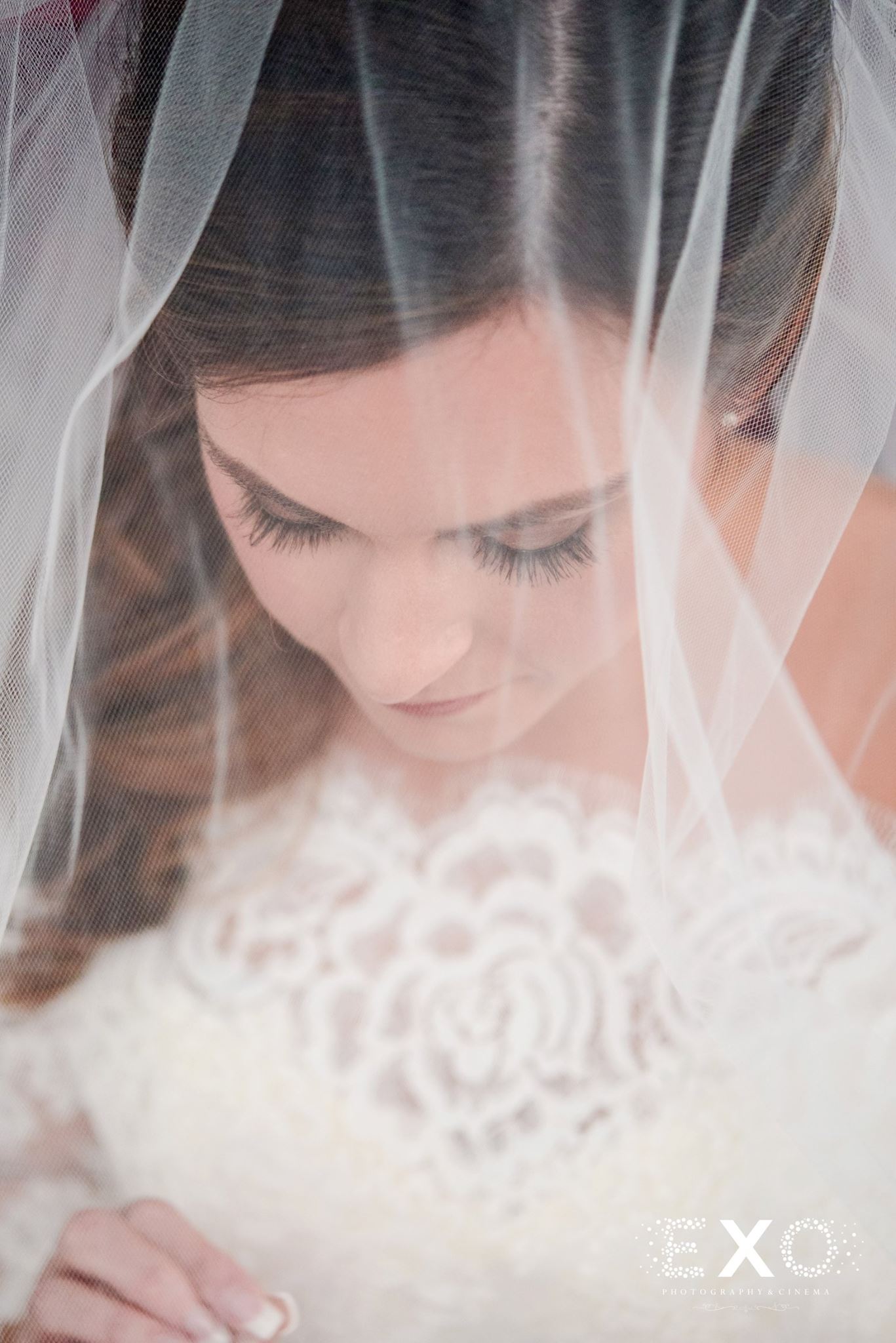 image of bride under veil wearing Kleinfeld Bridal gown