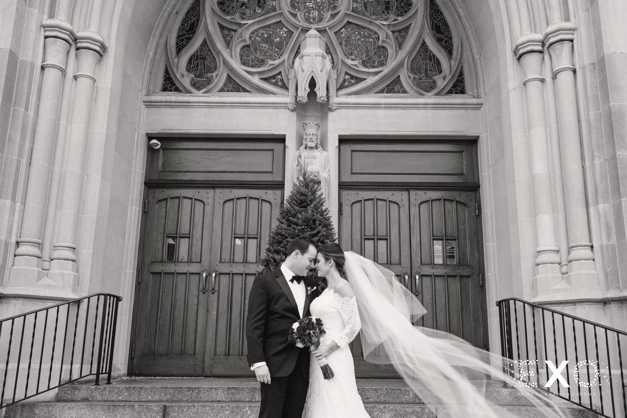 black and white image of bride and groom outside church ceremony