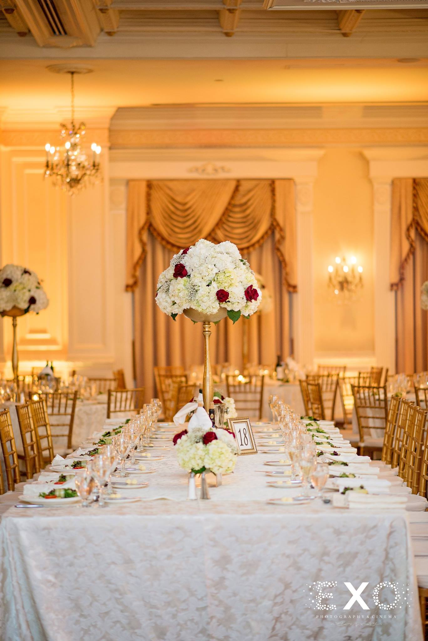 wedding table settings with floral arrangements by the art flower shop
