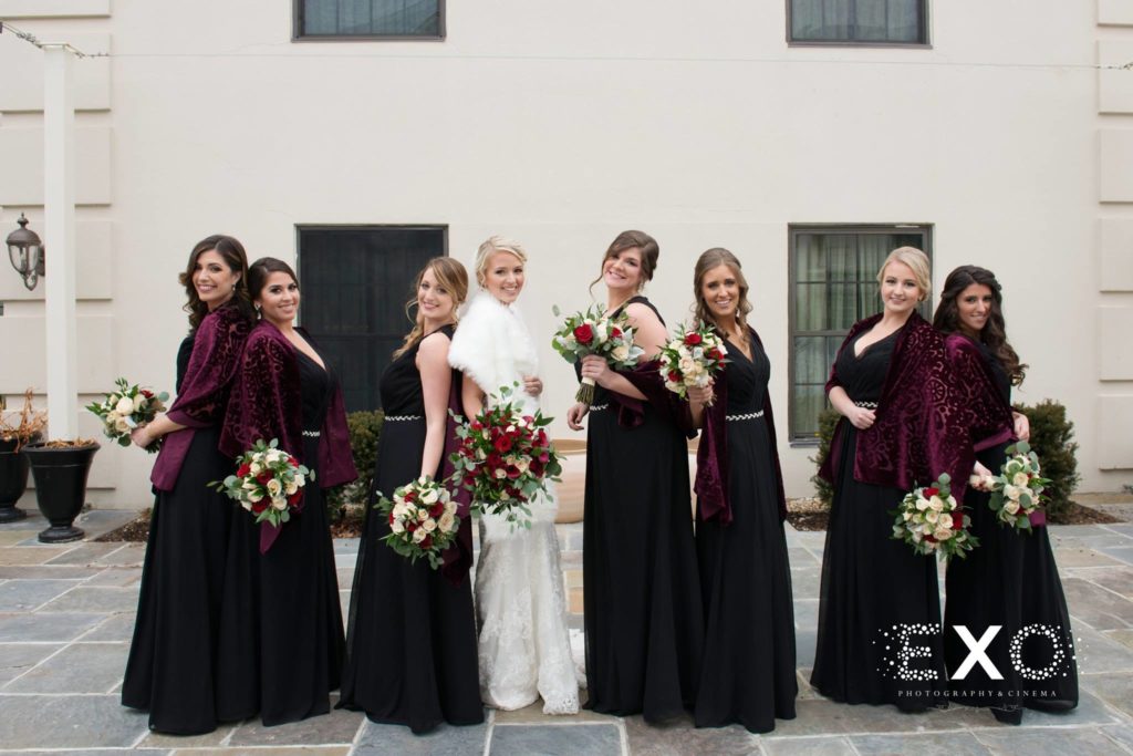 Bridal party posing outside Fox Hollow
