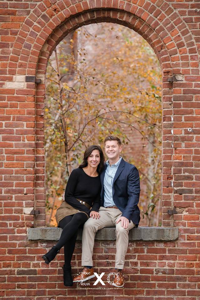 Couple sitting in brick opening