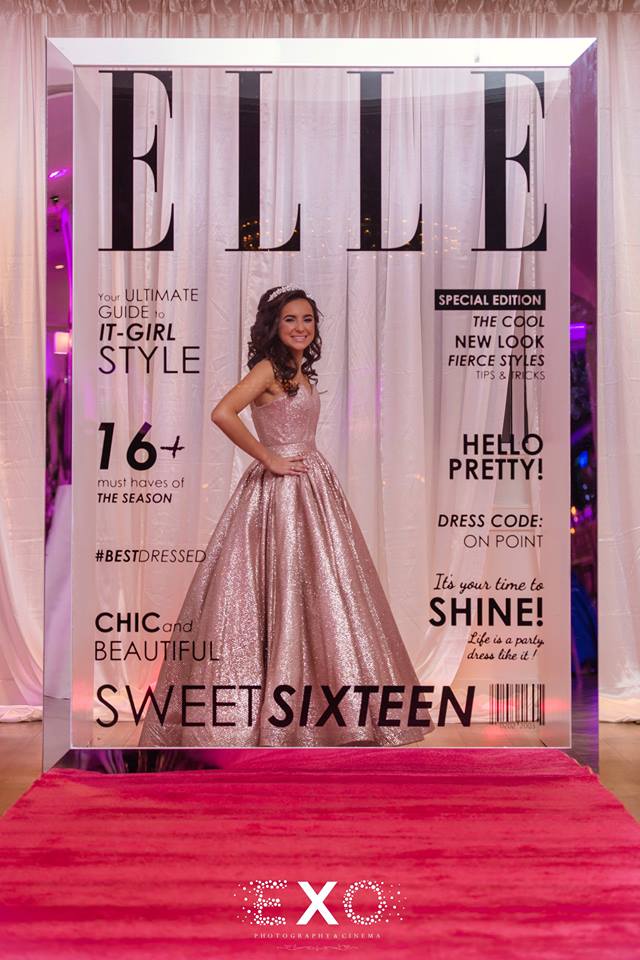 Elle posing with magazine backdrop