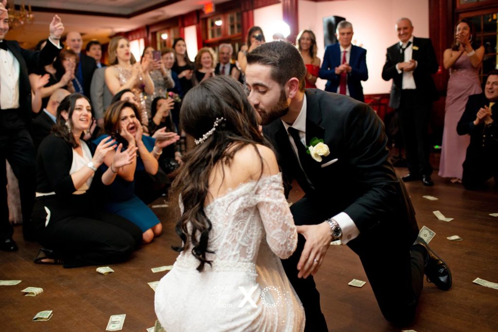 Bride and groom kissing on the dance floor at The Mansion at Oyster Bay