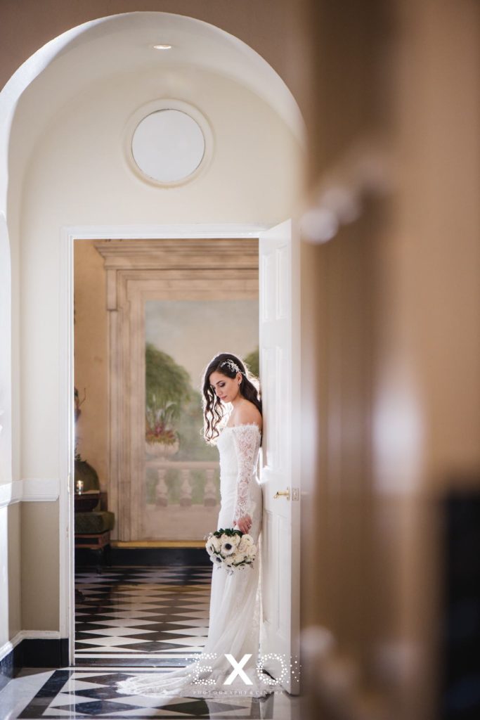 Bride standing in the doorway at The Mansion at Oyster Bay