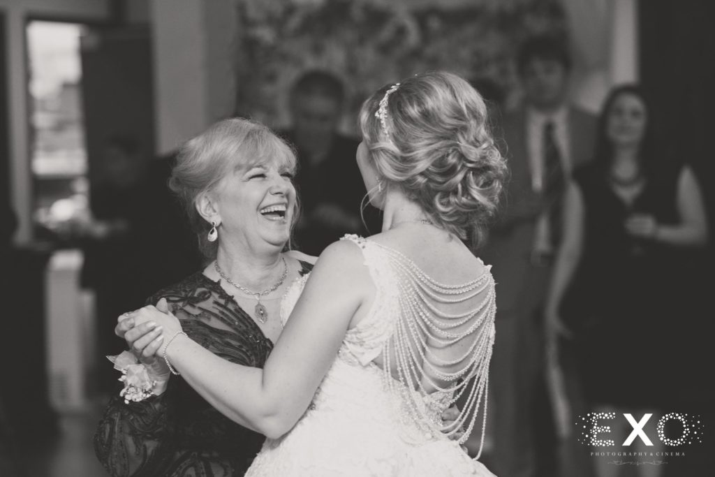 Bride and mother dancing and laughing at The Mansion at Oyster Bay