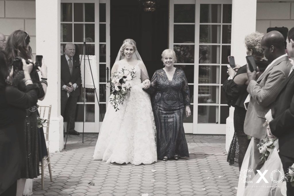 mother of bride walking her down the aisle at The Mansion at Oyster Bay