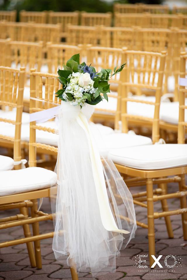 floral arrangement on ceremony chairs at The Mansion at Oyster Bay