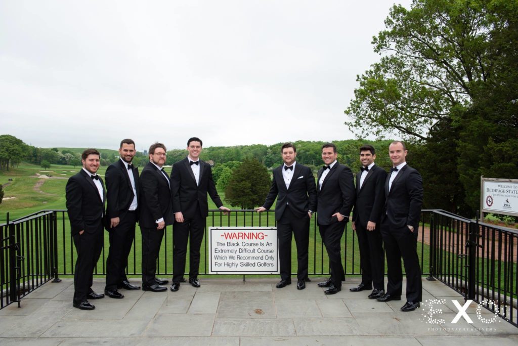 groom and groomsmen by the gold course at Heritage Club at Bethpage
