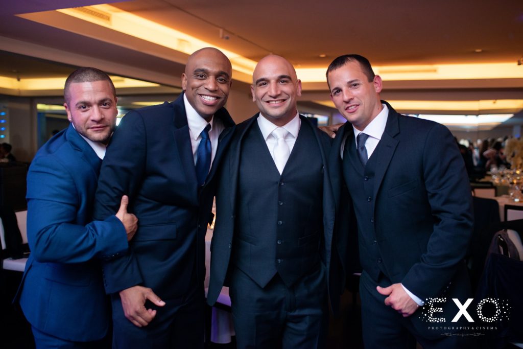 groom and groomsmen during reception at Harbor Club at Prime