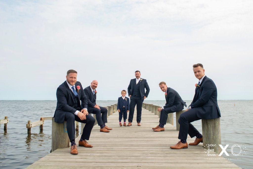 groomsmen on the dock posing at Lombardi's on the Bay