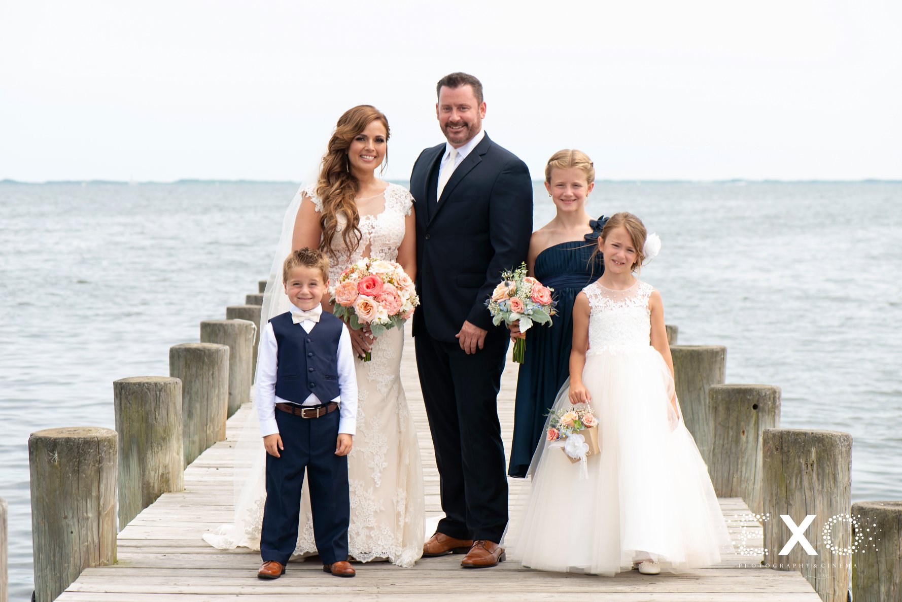 bride and groom with their children at Lombardi's on the Bay