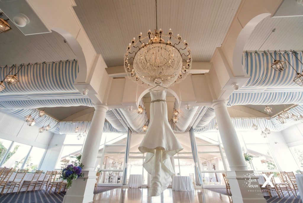 bride's dress hanging from the chandelier at Oceanbleu