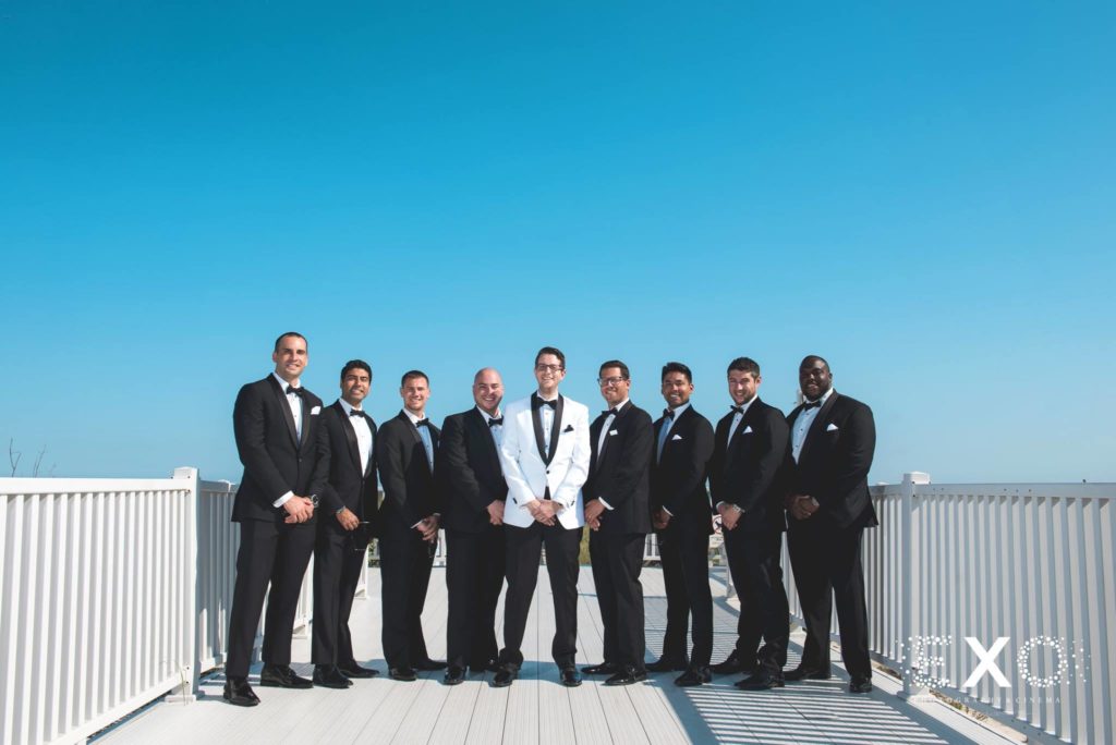 groom and groomsmen standing on the dock at Oceanbleu
