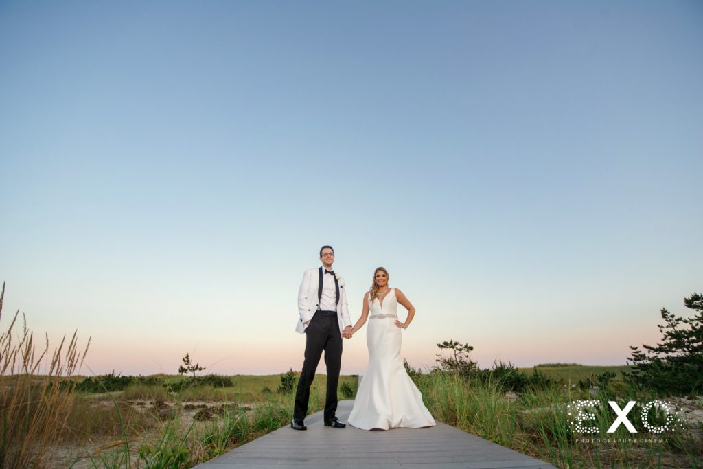 bride and groom on the boardwalk at Oceanbleu