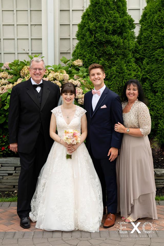 Bride and groom with parents at Fox Hollow