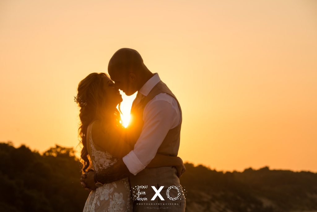 Bride and groom with sunset at Pavilion at Sunken Meadow