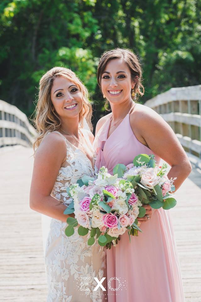bride and sister with bouquets