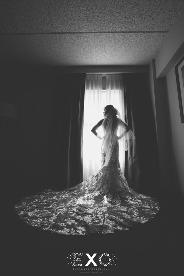 black and white stunning bride in window