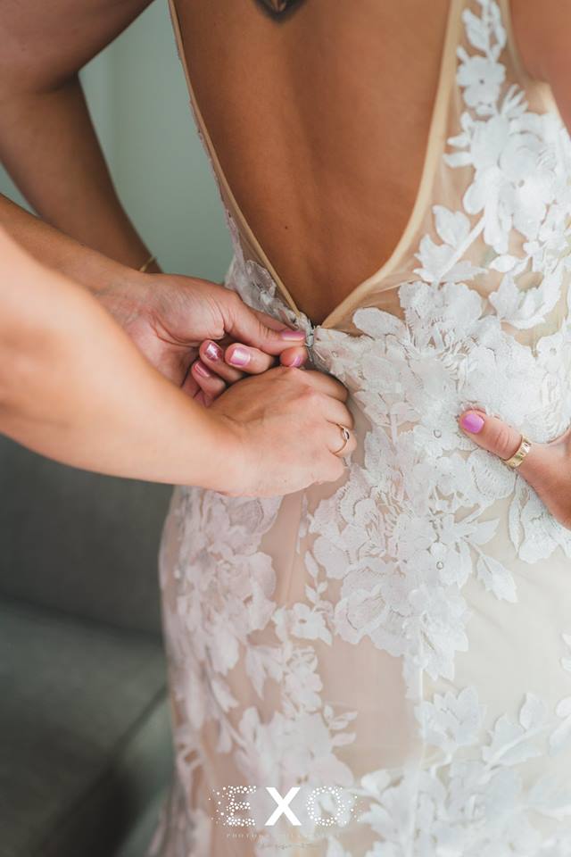 Zipping up the brides dress
