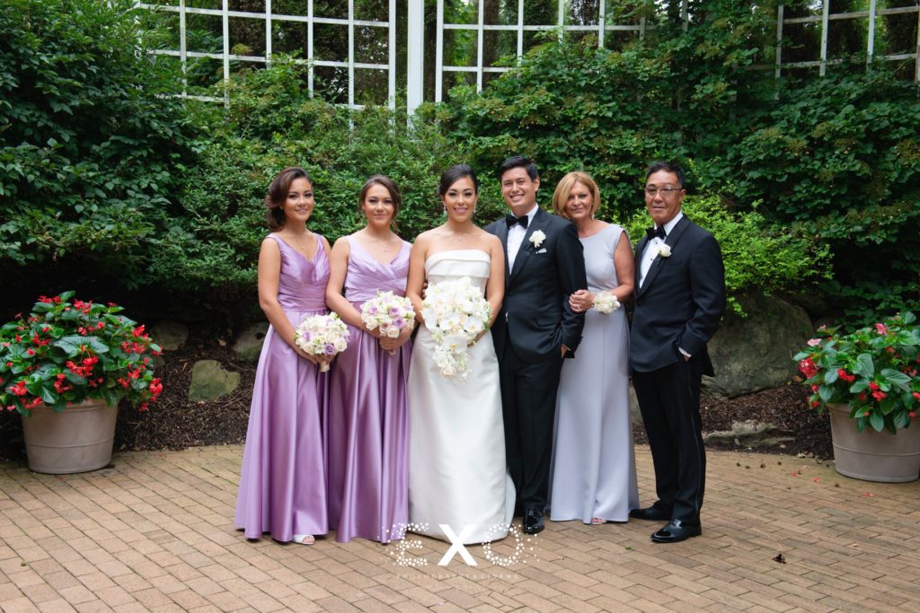 Bride and groom with bride's family at The Garden City Hotel